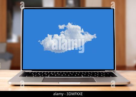 Laptop displaying a cumulus cloud with binary data against blue sky Stock Photo
