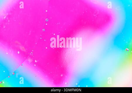 Minimalist abstract background with pink fluid texture and tiny oil droplets in liquid Stock Photo
