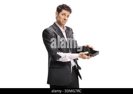 Sad poor man in a ragged suit holding an empty wallet isolated on white background Stock Photo