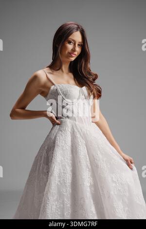 Elegant bride in a pearl strap lace ballgown with corset bodice Stock Photo