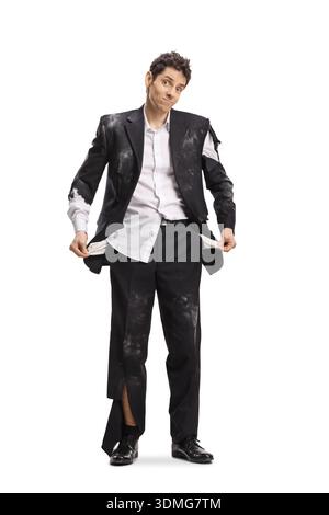 Unfortunate man in an old ripped suit showing his empty pockets isolated on white background Stock Photo