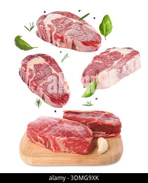 Fresh beef steaks falling on white background Stock Photo
