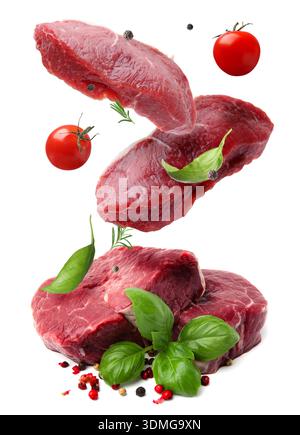 Fresh beef steaks falling on white background Stock Photo