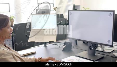 Working woman wearing beige blazer sitting at office desk, with laptop on raised stand, copy space Stock Photo