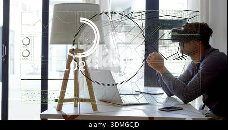 Leaning mid-adult man wearing dark shirt and glasses using AR interface on home desk with laptop Stock Photo