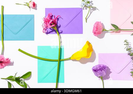 Composition with different envelopes and flowers on white background, closeup Stock Photo