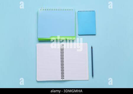 Composition with different notebooks on blue background Stock Photo