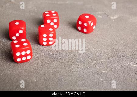 Red dices on grey background Stock Photo
