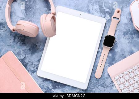 Composition with different modern gadgets and notebook on blue grunge background, closeup Stock Photo