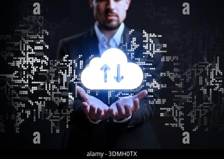 Man in business suit holds cloud symbol with data movement in a digital space Stock Photo