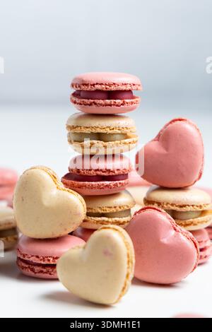 Different types of macarons are arranged on a flat surface. Stock Photo