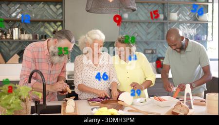 Preparing four adults chopping cabbage and peeling carrots at kitchen island, with cutting boards Stock Photo