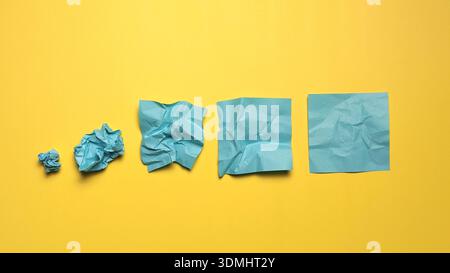 Transformation Process from Crumpled Paper to Smooth Sheet Representing Improvement and Progress Stock Photo