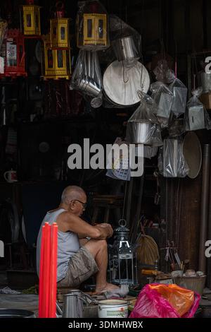 Elderly metal craftsman working with tools in traditional workshop Melaka 20.01.2026 Editorial only Stock Photo
