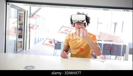 Using man wearing white VR headset and mustard tee manipulating red AI holograms at modern office Stock Photo