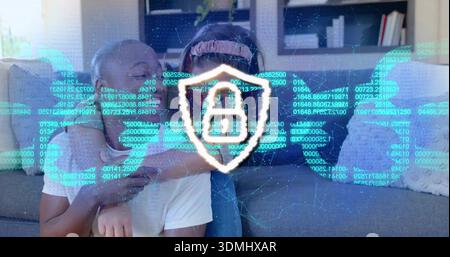 Hugging couple sitting on gray sofa at home wearing headband, showing shield lock and code overlay Stock Photo