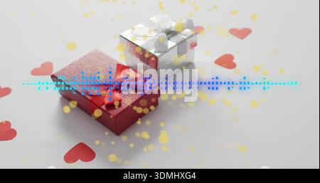Showing red-embossed and silver gift boxes on white table with red hearts blue waveform yellow dots Stock Photo
