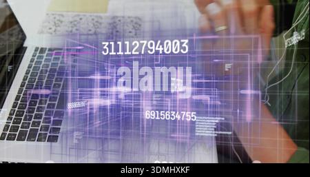 Typing Chinese man in olive-green shirt on laptop at desk, holographic numeric overlay, copy space Stock Photo