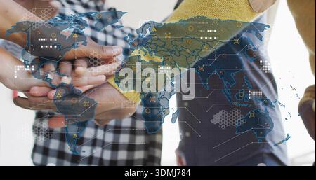 Joining team hands forming stack in office, with checkered sleeve, yellow knit, global map Stock Photo