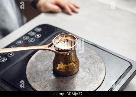 Traditional Turkish Coffee Brewing on Modern Electric Stove, Captured From Above Stock Photo