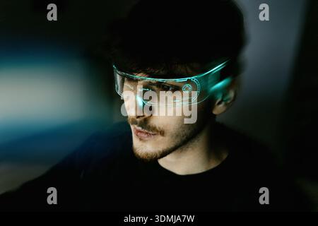 Young man using computer with led cyber augmented reality headset Stock Photo