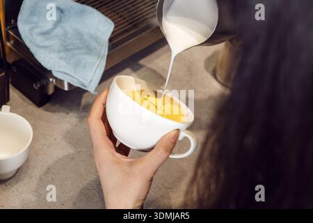 Barista Crafting Latte Art Design at Cozy Coffee Shop During Morning Hours Stock Photo