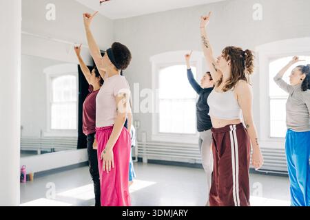 Diverse women practicing dance movements in studio rehearsal Stock Photo