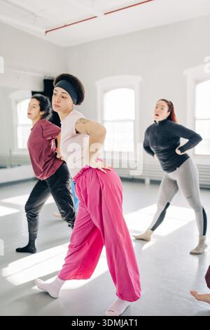Diverse women rehearsing dance movements in studio class Stock Photo