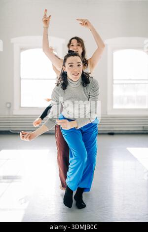 Young women practicing contemporary dance in studio Stock Photo