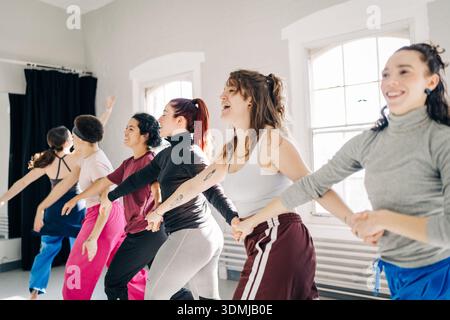 Diverse women dancing together during a studio rehearsal Stock Photo