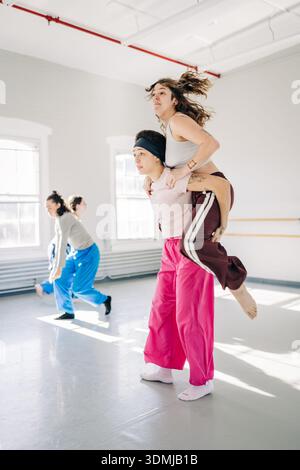 Dancers practicing choreography in modern dance studio Stock Photo