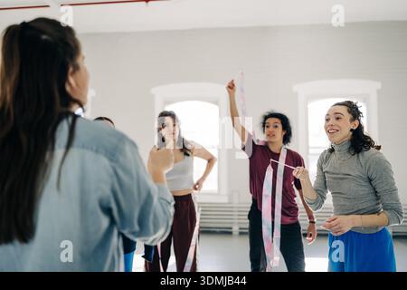 Group of diverse dancers learning rhythmic ribbon movements Stock Photo