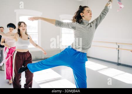Young dancers rehearsing choreography with ribbons in studio Stock Photo