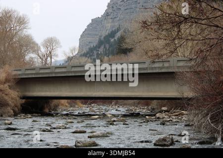 Quiet Mountain Bridge Crossing Rocky River Stock Photo