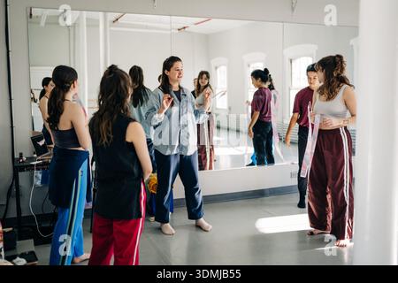 Dance instructor teaching choreography to students in studio Stock Photo