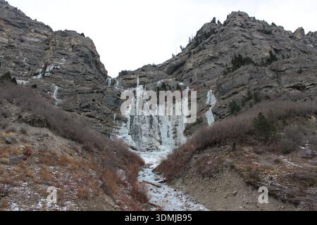 Winter Frozen Waterfall on Rocky Cliff Stock Photo