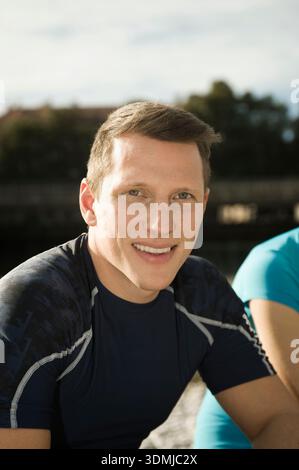 Portrait of young athletic man after outdoor fitness training smiling Stock Photo