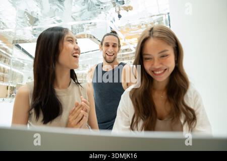 Diverse friends enjoying time indoors, laughing and having fun Stock Photo