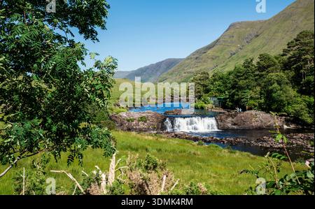 Aasleagh Falls is a waterfall and river in a mountain backdrop, popular for riverside walks, picnics & canyoning, County Mayo, Ireland Stock Photo