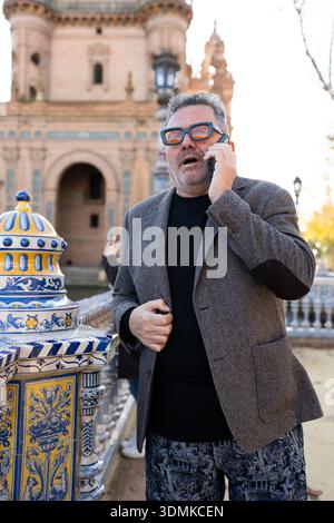 Man talking on phone in plaza de españa seville Stock Photo