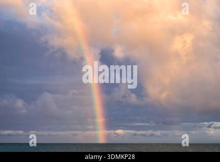 Rainbow over ocean with faint double rainbow. Kauai, Hawaii Stock Photo