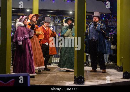 Toronto, ON, Canada - December 31, 2025: Christmas carolers in period costumes singing during WinterFest, capturing holiday spirit and festive enterta Stock Photo