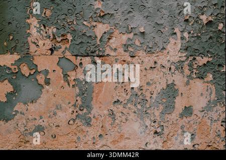 corroded surface with peelings, weathered metal with peeling paint and rusted patches for design Stock Photo