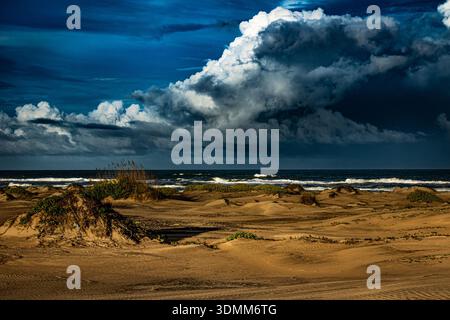 Incoming  A dramatic sky rolls in over a windswept beach. Stock Photo