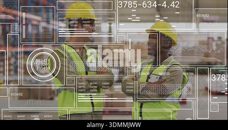 Standing two workers wearing yellow hard hats and hi-vis vests in aisle with racking, HUD overlay Stock Photo