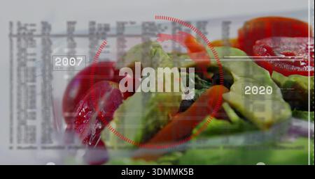 Displaying salad with avocado slices, cherry tomatoes in clear plate on table showing 2007 2020 HUD Stock Photo