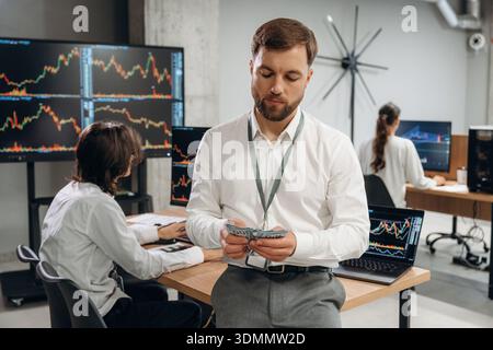 Counting the money. Business people are working with stock market exchange in office. Stock Photo