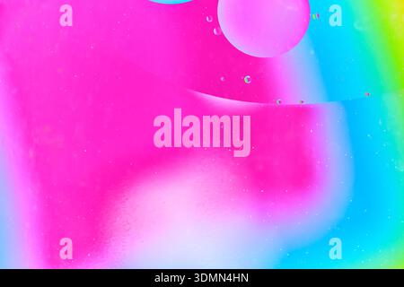 Close up of pink and white liquid spheres with small bubbles floating in water Stock Photo