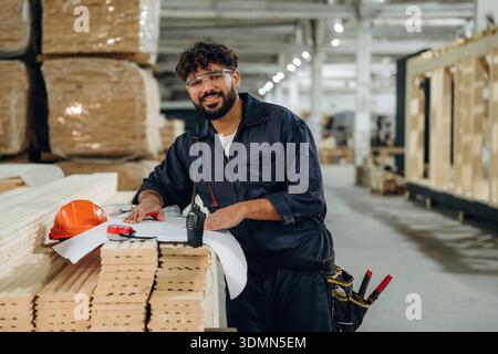In a professional workshop. Male carpenter working with wooden materials. Stock Photo