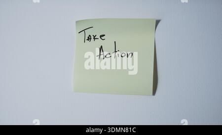 "Take Action" Handwritten on Green Sticky Note — Business Motivation and Proactive Mindset Concept Stock Photo